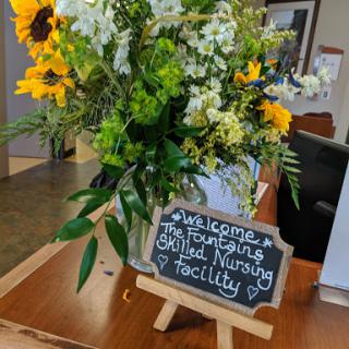 A warm welcome at the skilled nursing facility highlighted by a beautiful floral arrangement.