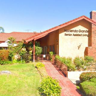 The entrance to a senior assisted living facility with well-maintained landscaping.
