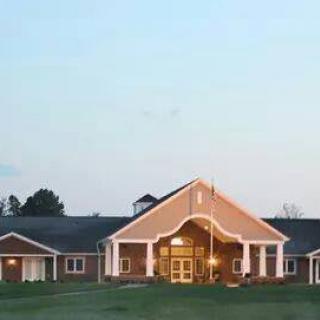 A community building with a welcoming entrance under a clear evening sky.