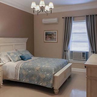 A cozy bedroom with classic furniture and soft lighting.