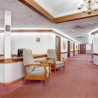 A spacious lobby with comfortable seating and soft lighting, creating a welcoming atmosphere.