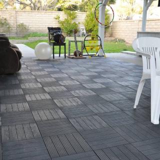 A well-kept patio with furniture and garden view.
