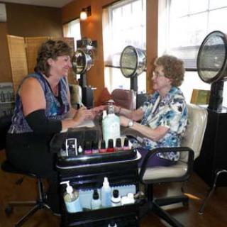 Two people enjoying a manicure session in a nail salon.