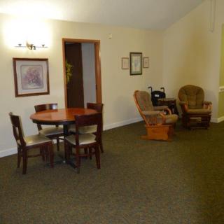 A cozy living and dining area with a round table and comfortable seating.