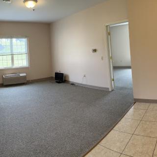 A spacious, vacant room with natural light and simple decor, ready for personalization.