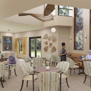 A modern lounge area with seating and artwork, featuring people interacting in a well-lit space.
