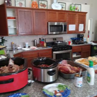 A bustling kitchen filled with various cooking appliances and ingredients, showcasing a lively food preparation scene.