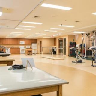 A spacious rehabilitation center equipped with exercise machines and therapy areas.