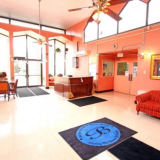 A bright and welcoming lobby area with seating and reception desk.