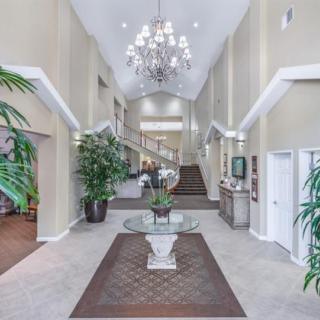 Spacious lobby with elegant chandelier and contemporary design.