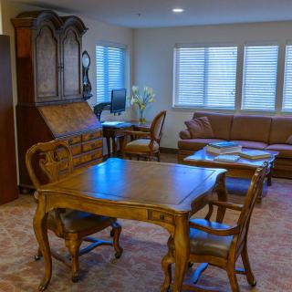 A cozy living room with antique wooden furniture and a warm ambiance.