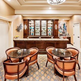 A cozy lounge area with elegant seating and a bar.