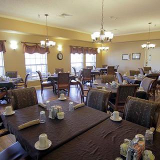 Spacious dining room with neatly arranged tables and elegant lighting.