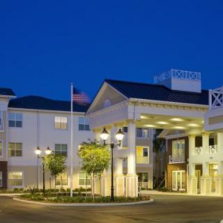A well-lit hotel building at night with a welcoming entrance.