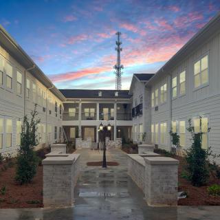 A modern building with a central courtyard and evening sky backdrop.