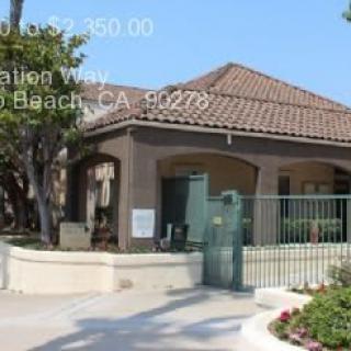 Residential property with a gated entrance and landscaped surroundings.
