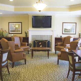 A cozy living room with a fireplace, TV, and comfortable seating arrangement.
