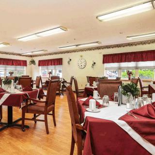 A well-decorated dining room with neatly arranged tables and chairs.