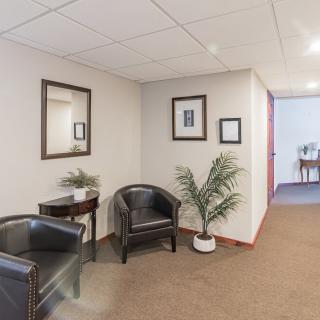 A professional waiting area with seating and decorative elements in an office setting.