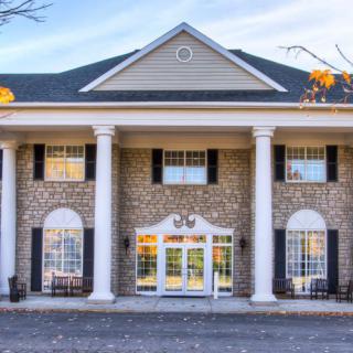 A classical building with prominent columns and symmetrical windows.
