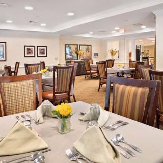 An elegant dining room with neatly arranged tables and chairs, ready for guests.