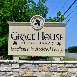 Sign for Grace House of Lake Travis, promoting excellence in assisted living.