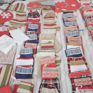 A colorful assortment of fabric pieces laid out for a holiday crafting project.