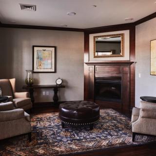 A cozy living room with comfortable seating, a fireplace, and elegant decor.