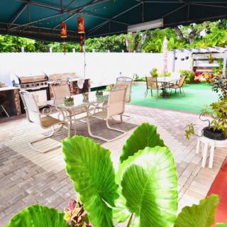A cozy outdoor patio area with seating and lush greenery.
