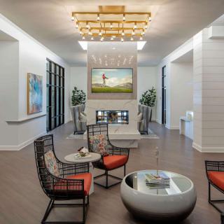 A modern living room with stylish furniture and a fireplace centerpiece.