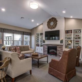 A cozy living room with a fireplace, comfortable seating, and a television.