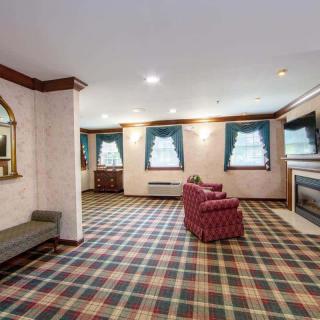 A traditional living room with plaid carpet and comfortable seating.