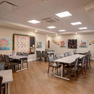 A modern dining area with artwork displayed on the walls.