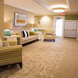 A well-lit lobby area featuring comfortable seating and elegant dcor.