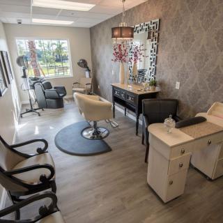 A modern hair salon with stylish decor and multiple workstations.