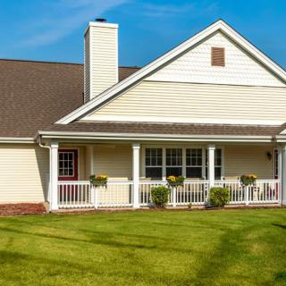 A suburban house with a well-maintained lawn and a cozy porch.
