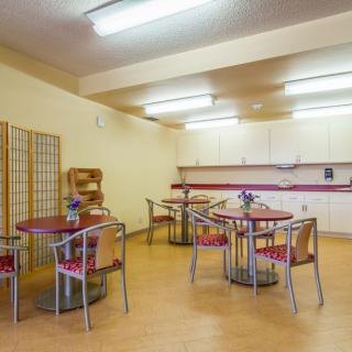 A spacious kitchen and dining area with modern furniture and bright lighting.