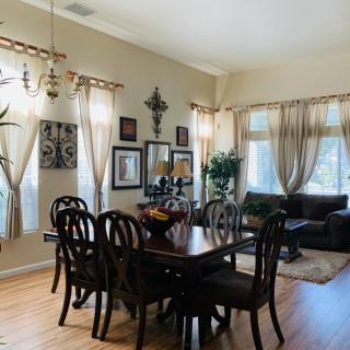 A well-lit dining and living area with elegant furnishings and decor.