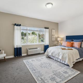 A modern and spacious bedroom with stylish decor and ample natural light.