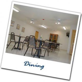 An empty dining area with neatly arranged tables and chairs.