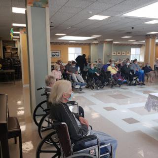 Residents gathered in a community activity room.