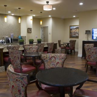 A cozy dining area with elegant chairs and tables, ideal for a relaxing meal.