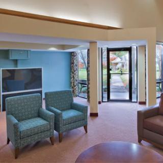 A cozy living room with comfortable seating and a large television.