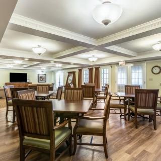 A spacious and well-lit dining area with wooden tables and chairs.