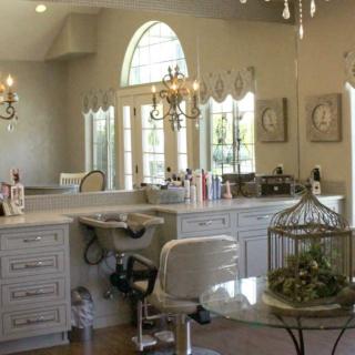 Elegant bathroom vanity with chandeliers and decorative accents.