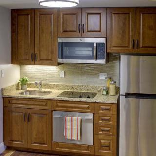 A modern kitchen with wooden cabinets and stainless steel appliances.