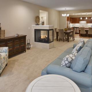 A spacious open-concept living and dining area featuring a cozy fireplace and comfortable seating.