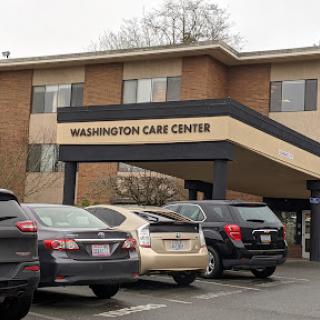 Exterior view of the Washington Care Center with parked vehicles.