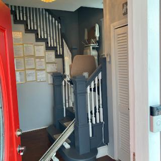 A glimpse of a stylish interior featuring a red entrance door and a staircase leading to the upper level.
