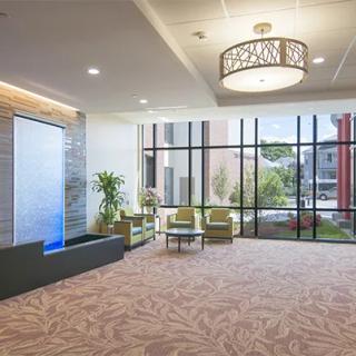 A modern lobby with comfortable seating and large windows providing ample natural light.